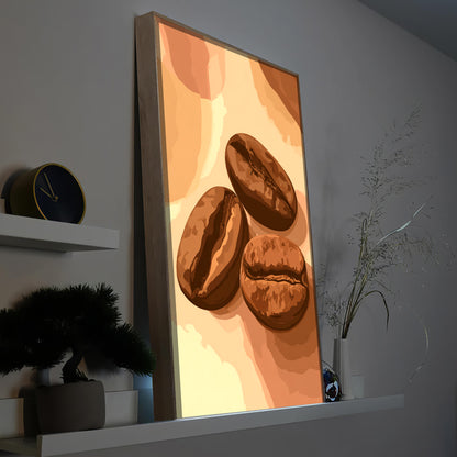 Gerahmtes LED-Bild mit drei Kaffeebohnen in Braun auf hellem Hintergrund